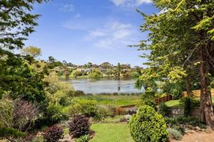 a view of a lake from a garden at Bellarine Lake House Ocean Grove in Ocean Grove