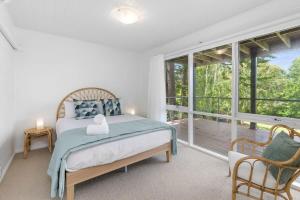 a bedroom with a bed and a large window at Bellarine Lake House Ocean Grove in Ocean Grove