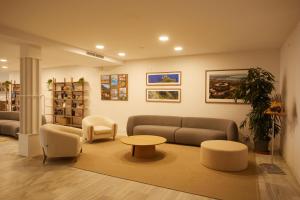 a living room with a couch and a table and chairs at Inmood Aucanada 4 Sup in Port d'Alcudia