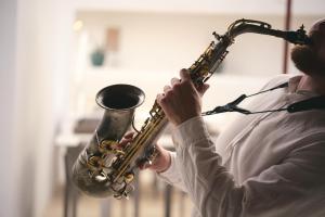 a man playing a saxophone in a room at Inmood Aucanada 4 Sup in Port d'Alcudia