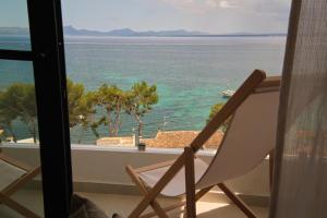 a chair sitting on a balcony looking out at the ocean at Inmood Aucanada 4 Sup in Port d'Alcudia