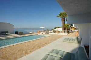 a villa with a pool and a view of the ocean at Inmood Aucanada 4 Sup in Port d'Alcudia