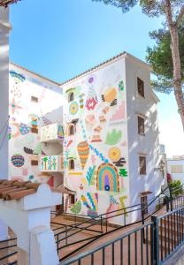 un bâtiment avec une fresque sur son côté dans l'établissement Flipflop Surfing Playa, à Santa Ponsa