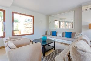 a living room with a couch and a table at Flipflop Surfing Playa in Santa Ponsa