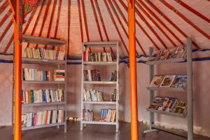 two shelves filled with books in a tent at Kampaoh Côte Sauvage in Saint-Clément-des-Baleines