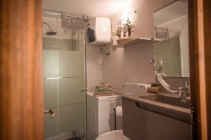 a small bathroom with a toilet and a sink at Holiday Gufetto in Pietra Ligure