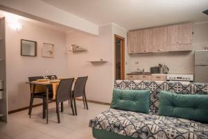 a living room with a table and a couch at Holiday Gufetto in Pietra Ligure