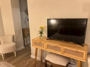 a flat screen tv sitting on top of a wooden entertainment center at Casa da vila in Faro +22 photos