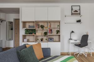 a living room with a couch and a desk at Fantasy House in Vilnius