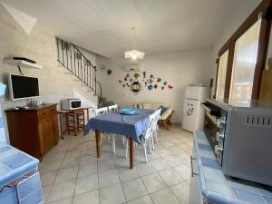 a kitchen and dining room with a table and chairs at L'Incanto Tanca Piras in Nebida +56 photos