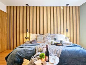 a bedroom with a large bed with a bottle of wine at Ferienhaus Biograci in Široki Brijeg