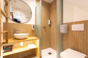 a bathroom with a sink and a mirror at Malaga Stop Hostel AB in Málaga