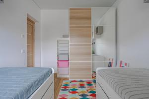 a bedroom with two beds and a closet at Fantasy House, cozzy apartmens, free parking, long stays welcome in Vilnius