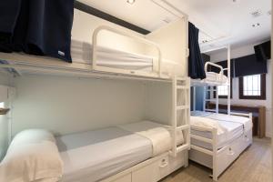 a room with two bunk beds in a room at Malaga Stop Hostel AB in Málaga