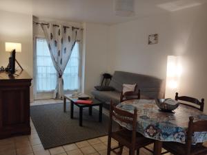a living room with a couch and a table at L'Écluse in Dieppe