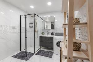 a bathroom with a shower and a washing machine at Fantasy House, cozzy apartmens, free parking, long stays welcome in Vilnius +50 photos