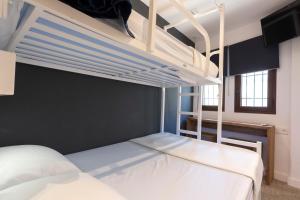 a bedroom with two bunk beds in a room at Malaga Stop Hostel AB in Málaga