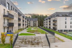 a row of apartment buildings with stairs between them at Fantasy House, cozzy apartmens, free parking, long stays welcome in Vilnius