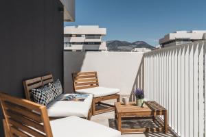 a patio with two chairs and a table on a balcony at tuGuest Mirador Norte in Granada