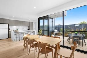 a kitchen and dining room with a table and chairs at Torquay Central Beach Retreat in Torquay