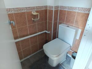 a bathroom with a toilet in a tiled room at Remarkable 4-Bed House in Chatham in Chatham