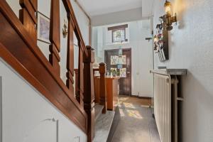 a staircase in a house with a wooden stair case at Gillis Eight by Romy&Travis in Bruges