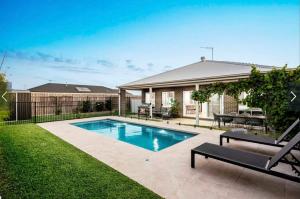 a swimming pool in the yard of a house at Park Front Villa with sparkling swimming pool in Saint Leonards