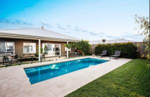 a swimming pool in the backyard of a house at Park Front Villa with sparkling swimming pool in Saint Leonards