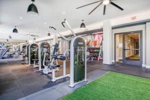 a gym with rows of tread machines and a green rug at Blueground Mountain View gym pool near retail SFO-1715 in Los Altos