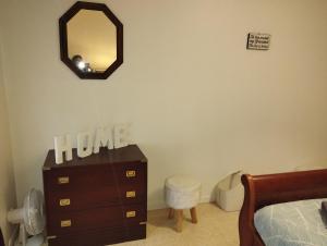 a bedroom with a dresser and a mirror at L'Écluse in Dieppe