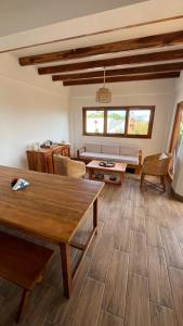 a living room with a wooden table and chairs at Villas del Mar in Las Tunas
