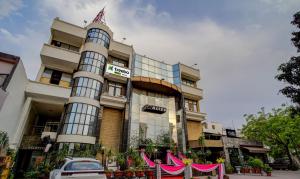 a building with a car parked in front of it at Treebo Bliss in Jaipur