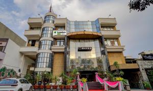 a building with a car parked in front of it at Treebo Bliss in Jaipur