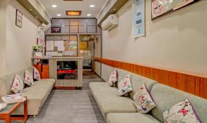 a waiting room with two couches and a fireplace at Treebo Bliss in Jaipur