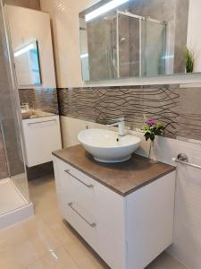 a bathroom with a sink and a mirror at Ukiel Park J&J in Olsztyn +9 photos