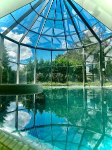 a glass igloo building with a pool in it at Hotel SPA Wieniawa in Rekowo
