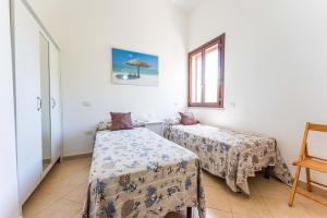 Tempat tidur dalam kamar di Villa Stella Cala Sinzias