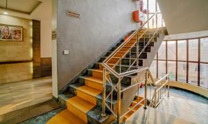 a spiral staircase in a building with a pool at Treebo Bliss in Jaipur +37 photos
