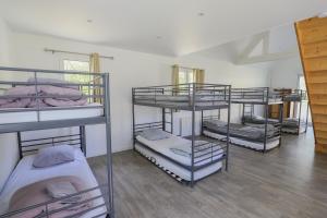 a room with four bunk beds in a room at Crazy Villa Ecottay 61 - Heated pool & sauna - 2h from Paris - 30p in La Loupe +45 photos