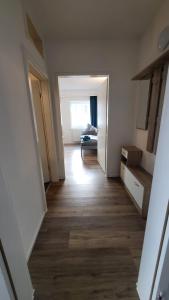 a hallway of an apartment with a room with a bed at Boardinghouse Heilbronn in Heilbronn