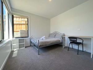 a bedroom with a bed and a chair and a window at 3 bedroom Apartment at Kingston in Kingston