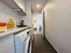 a kitchen with a washer and dryer in a room at 3 bedroom Apartment at Kingston in Kingston
