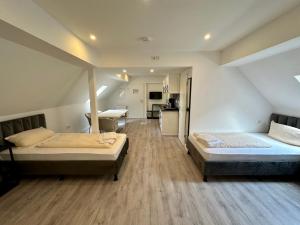 a large room with two beds and a kitchen at Durmaz Hotel in Hannover