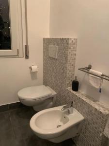 a bathroom with a white toilet and a sink at SpazioSanta in Santa Margherita Ligure