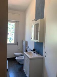 a bathroom with a sink and a toilet and a window at SpazioSanta in Santa Margherita Ligure