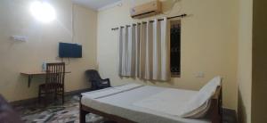 a hospital room with a bed and a desk at Uncle Paul's Mansion in Cochin