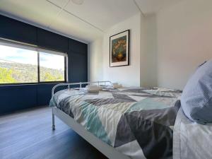 a bedroom with a bed and a large window at Wellesley Mountain View Getaway near City in Hobart