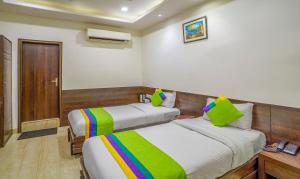 a hotel room with two beds in a room at Treebo Bliss in Jaipur