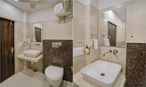 a bathroom with a toilet and a sink and a mirror at Treebo Bliss in Jaipur