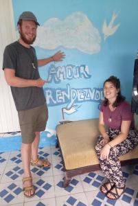 a man standing next to a woman in a room at Sea Side Elvis HomeStay in Korotogo